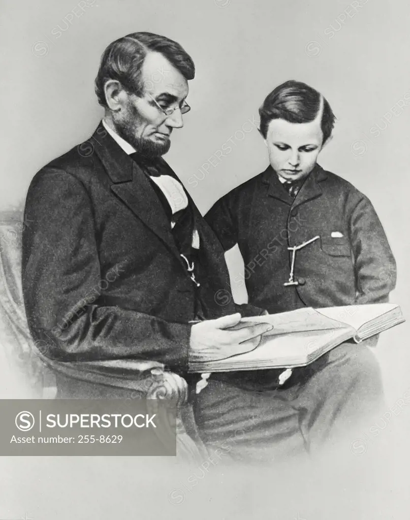 Vintage photograph. Abraham Lincoln reading to his son Tad February 9, 1864 Photography by Anthony Berger of Mathew Brady Studio