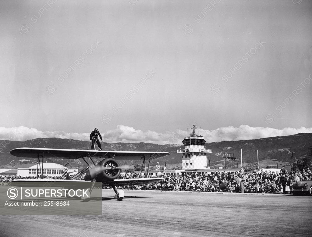 Stock Photo: 255-8634 Wing walker standing on top of aircraft
