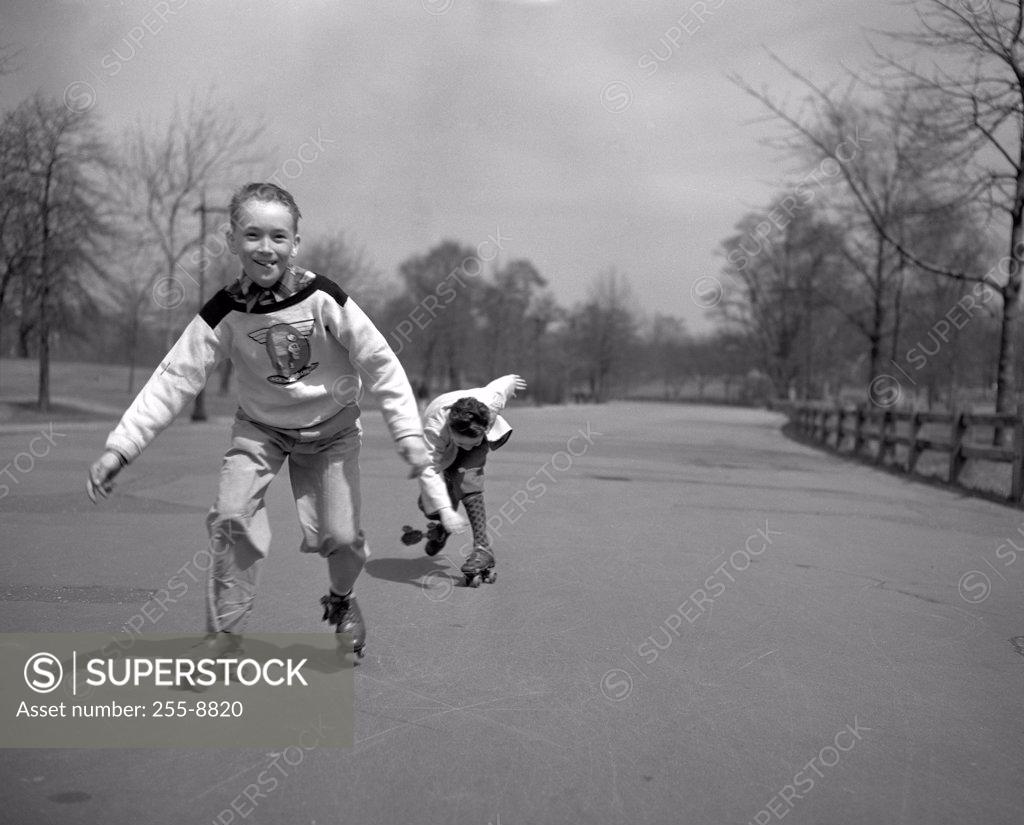 Stock Photo: 255-8820 Children roller skating in park