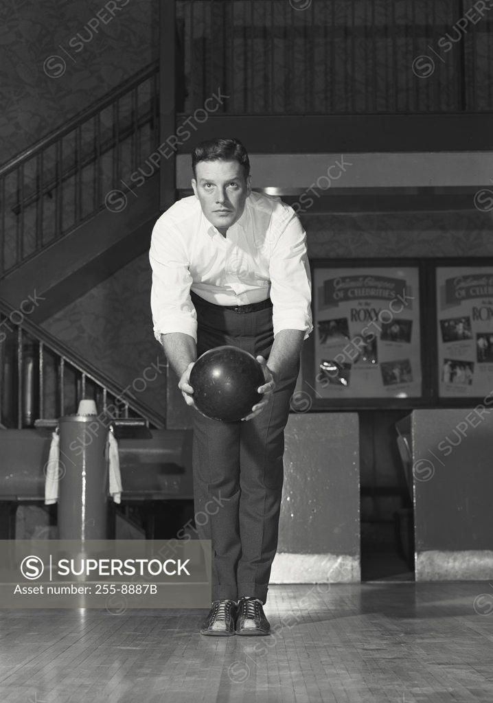 Stock Photo: 255-8887B Young adult man bowling