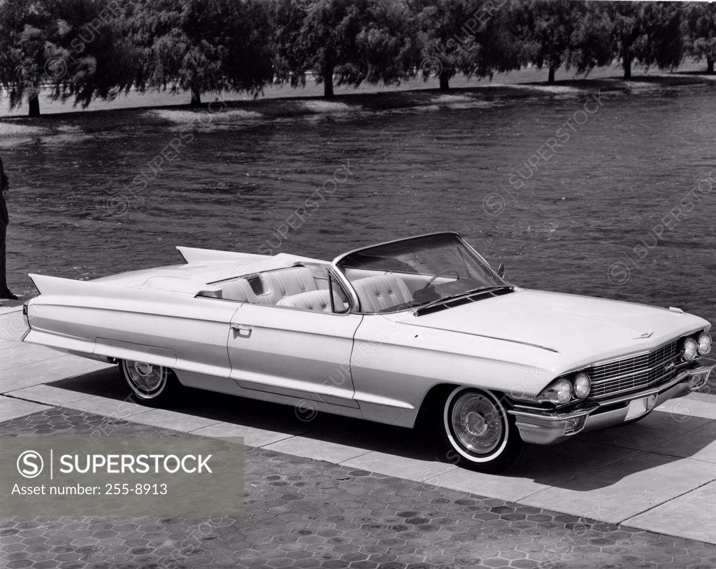 Stock Photo: 255-8913 High angle view of a convertible car parked near lake, 1962 Cadillac Series 62