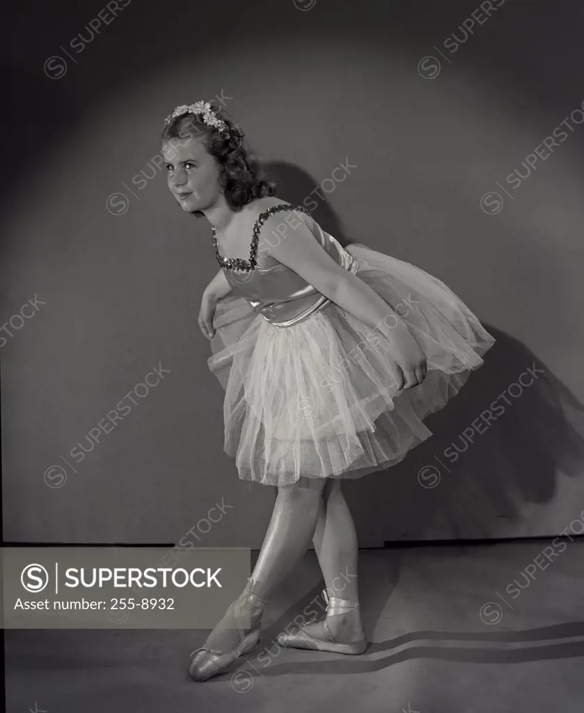Ballet dancer girl bowing at stage