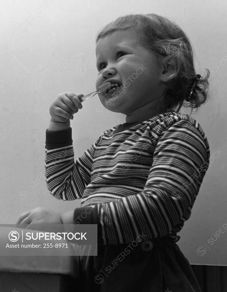 Stock Photo: 255-8971 Small girl brushing teethes