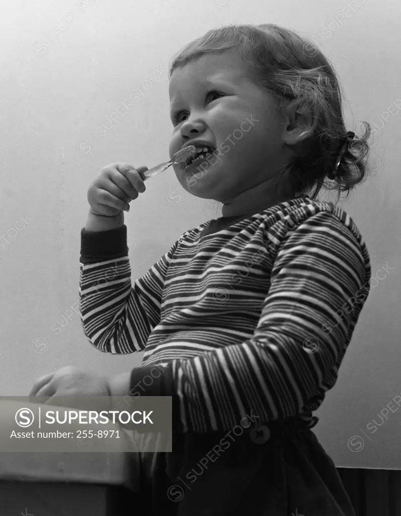 Small girl brushing teethes
