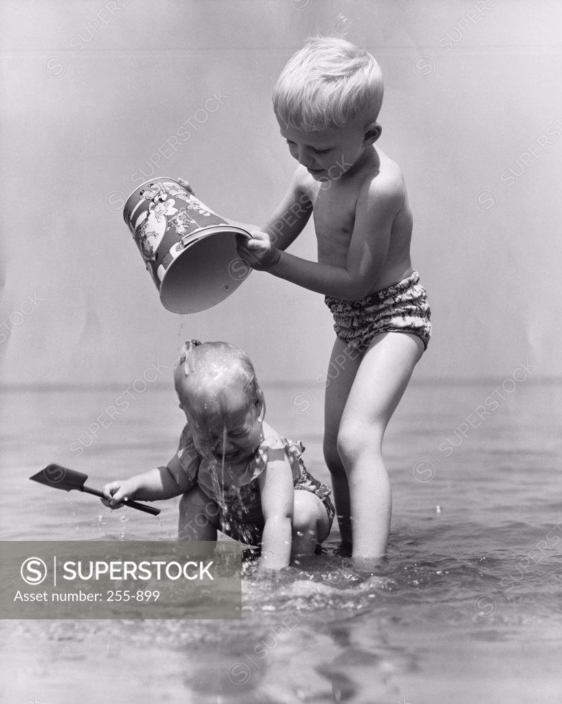Stock Photo: 255-899 Boy and girl playing in water