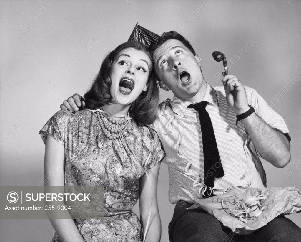Stock Photo: 255-9004 Young couple singing at party