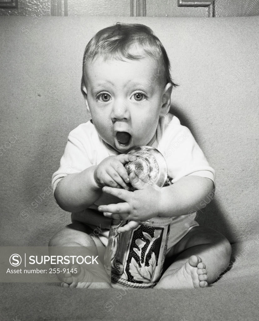 Stock Photo: 255-9145 Portrait of a baby boy holding a jar