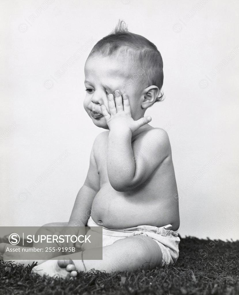 Stock Photo: 255-9195B Close-up of a baby boy rubbing his eye