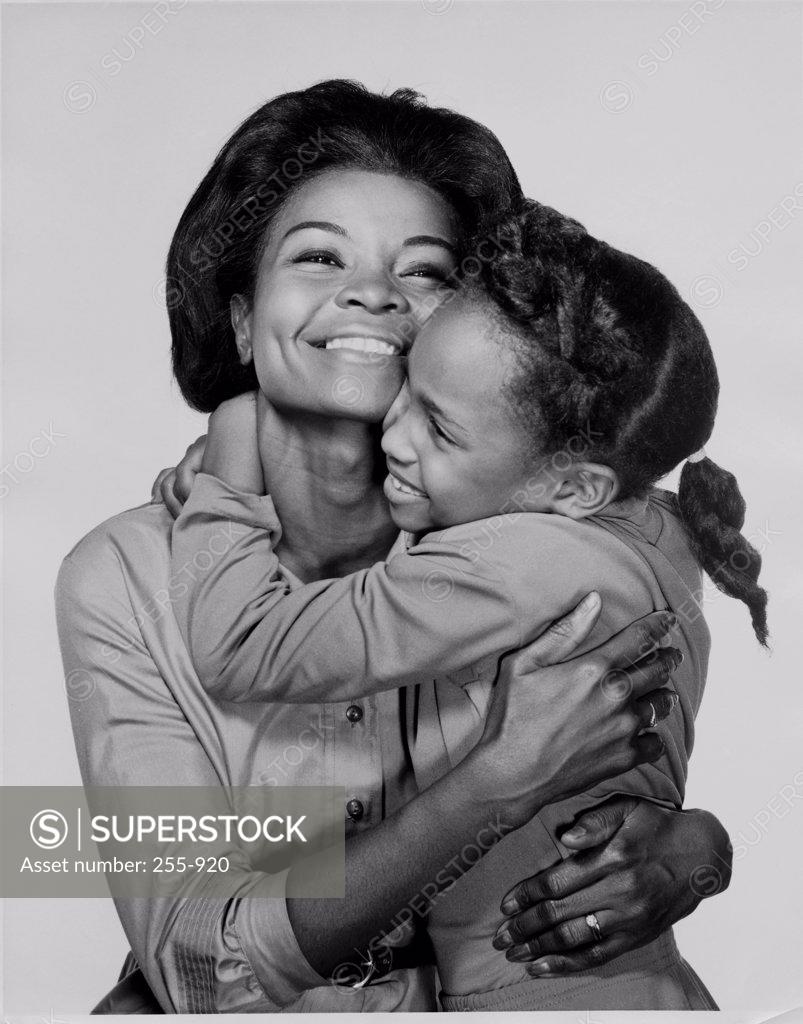 Stock Photo: 255-920 Mother hugging her daughter