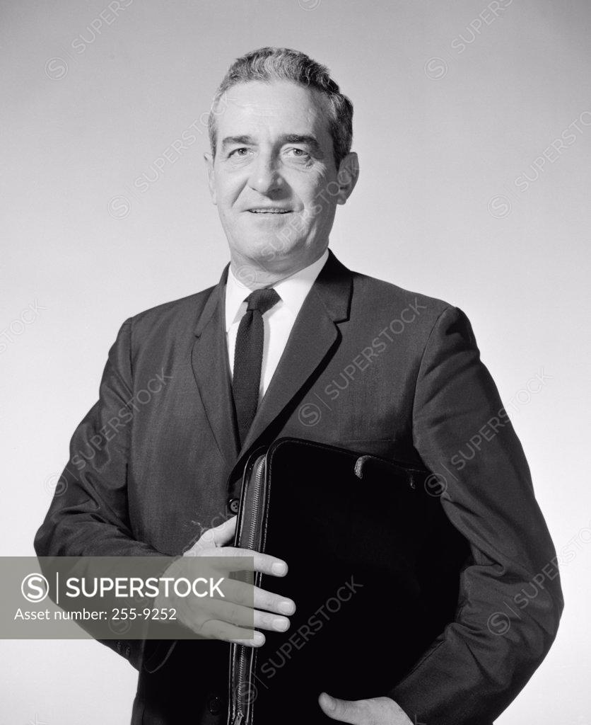 Stock Photo: 255-9252 Portrait of a businessman holding a briefcase