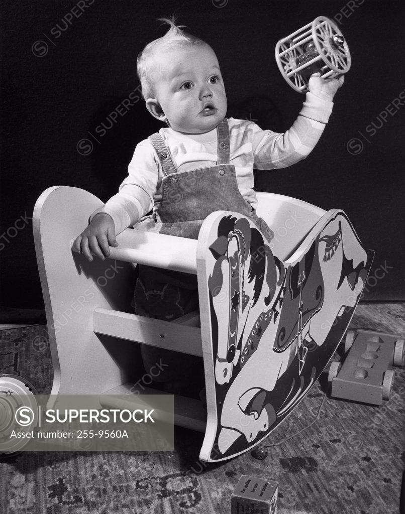 Stock Photo: 255-9560A baby sitting in rocking horse