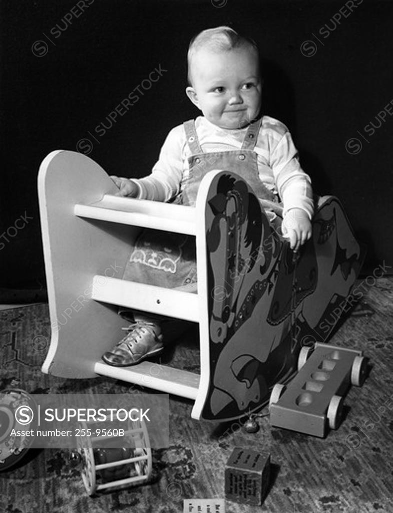 Stock Photo: 255-9560B Baby sitting in toy chair