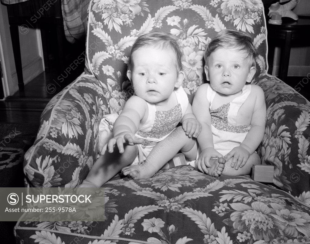 Stock Photo: 255-9578A Two baby girls sitting on armchair