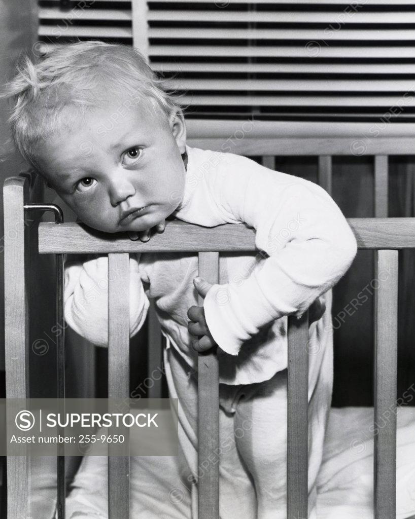 Stock Photo: 255-9650 Close-up of a baby boy leaning over a crib