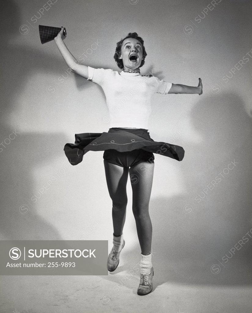 Stock Photo: 255-9893 Teenage girl shouting with her arms outstretched