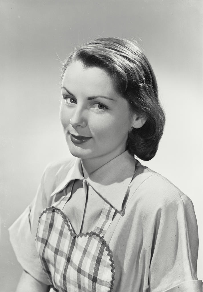 Portrait of woman wearing tartan apron
