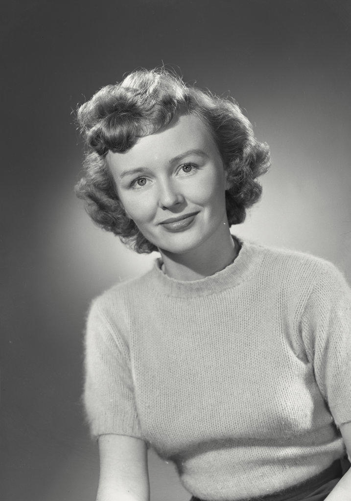Portrait of woman in sweater smiling.