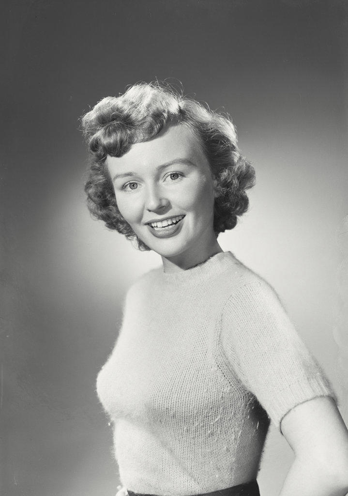 Portrait of woman in sweater smiling.