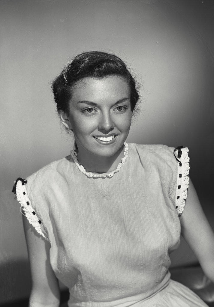 Close-up of a young brunette woman smiling