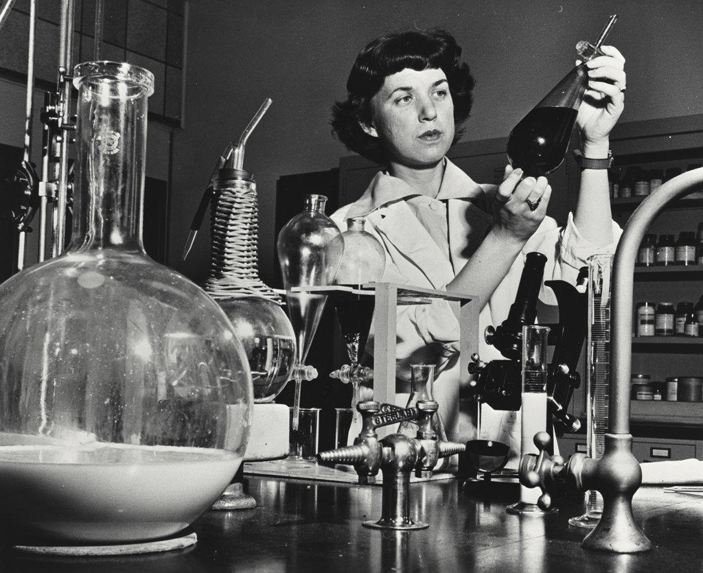 Research chemist making physical tests on oils and other organic materials at the manufacturing research laboratories