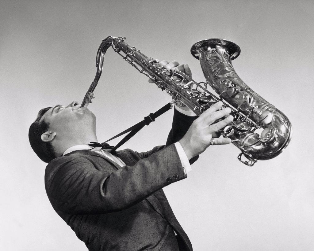 Mid adult man playing the saxophone
