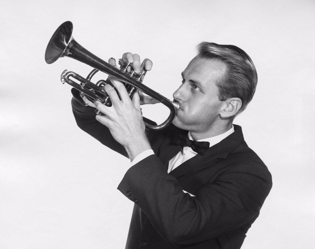 Close-up of a mid adult man playing a trumpet