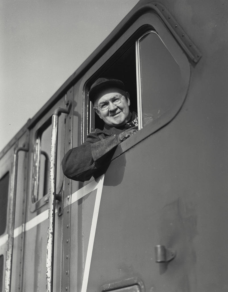 engineer looking out of cab of a diesel locomotive