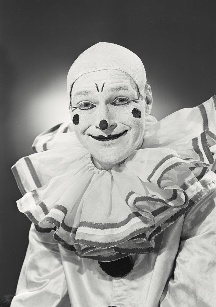 Portrait of clown in collar smiling.