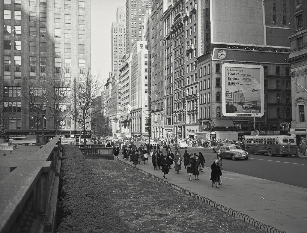 crowd walking down street in new York city