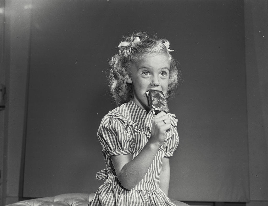 Little girl smiling with ice cream pop