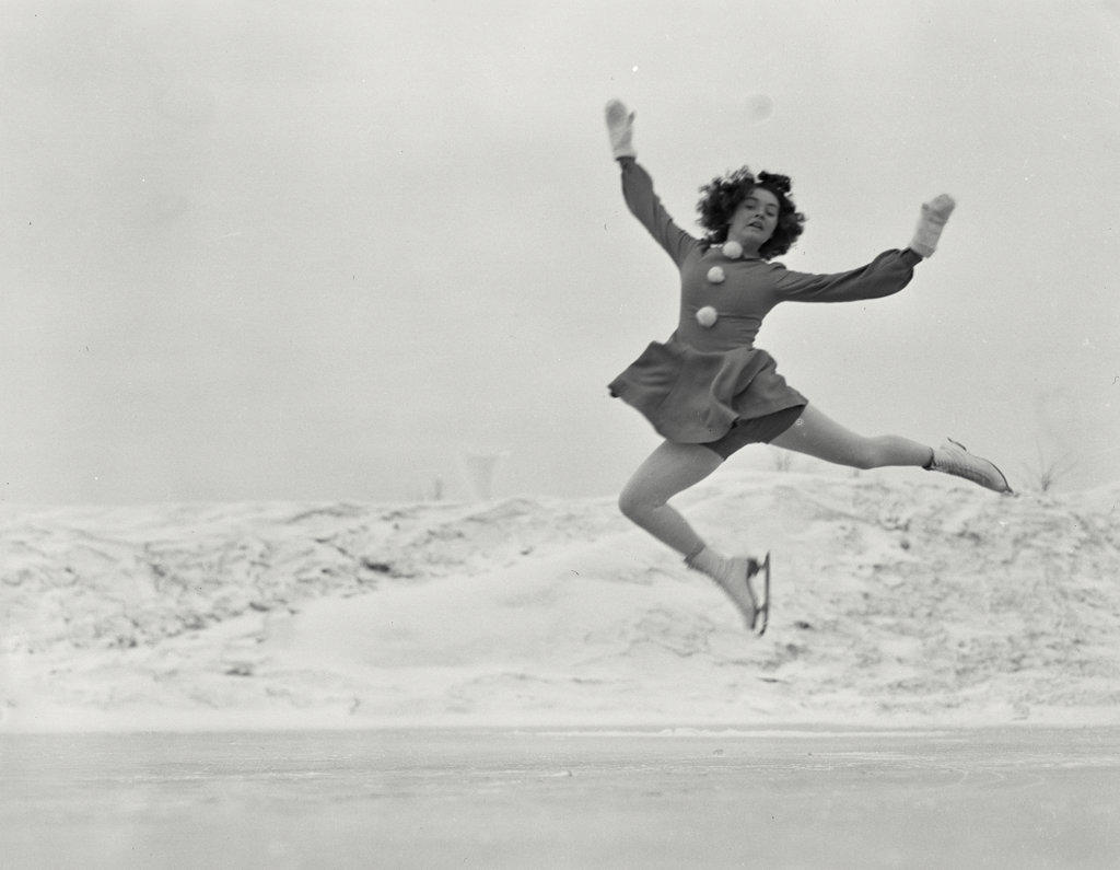 Female figure skater in air during jump