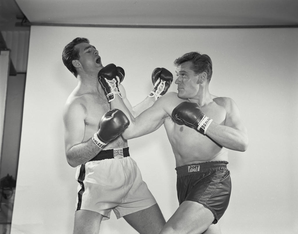 Two mid adult men boxing