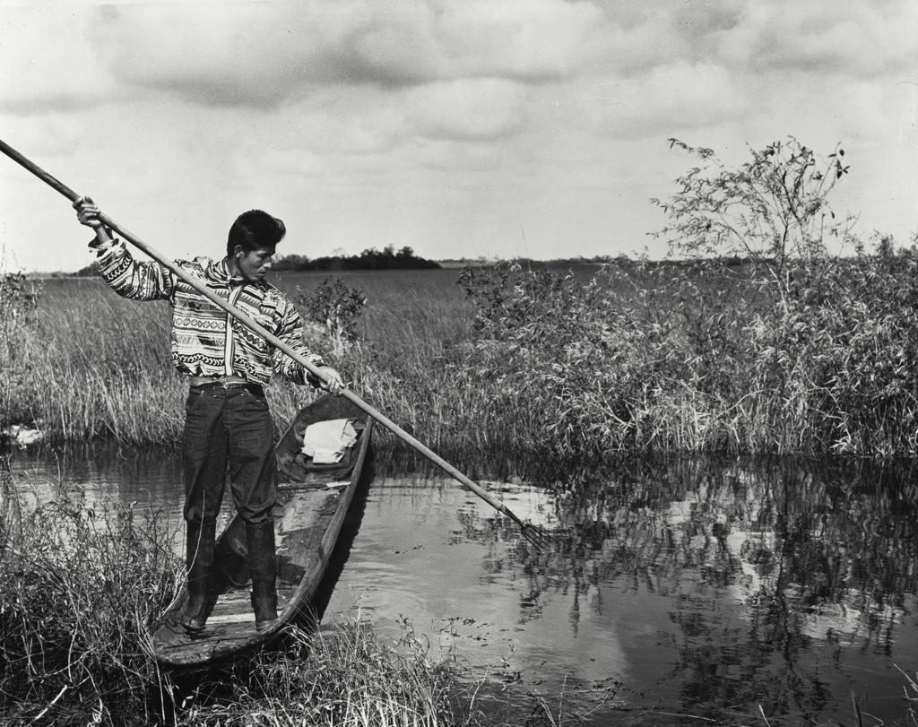 USA, Florida, Everglades National Park, Seminole man spear fishing in lake