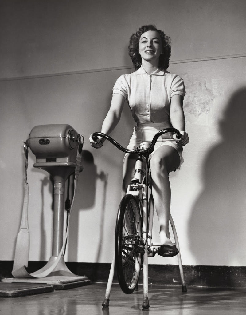 Young woman exercising on an exercise bike