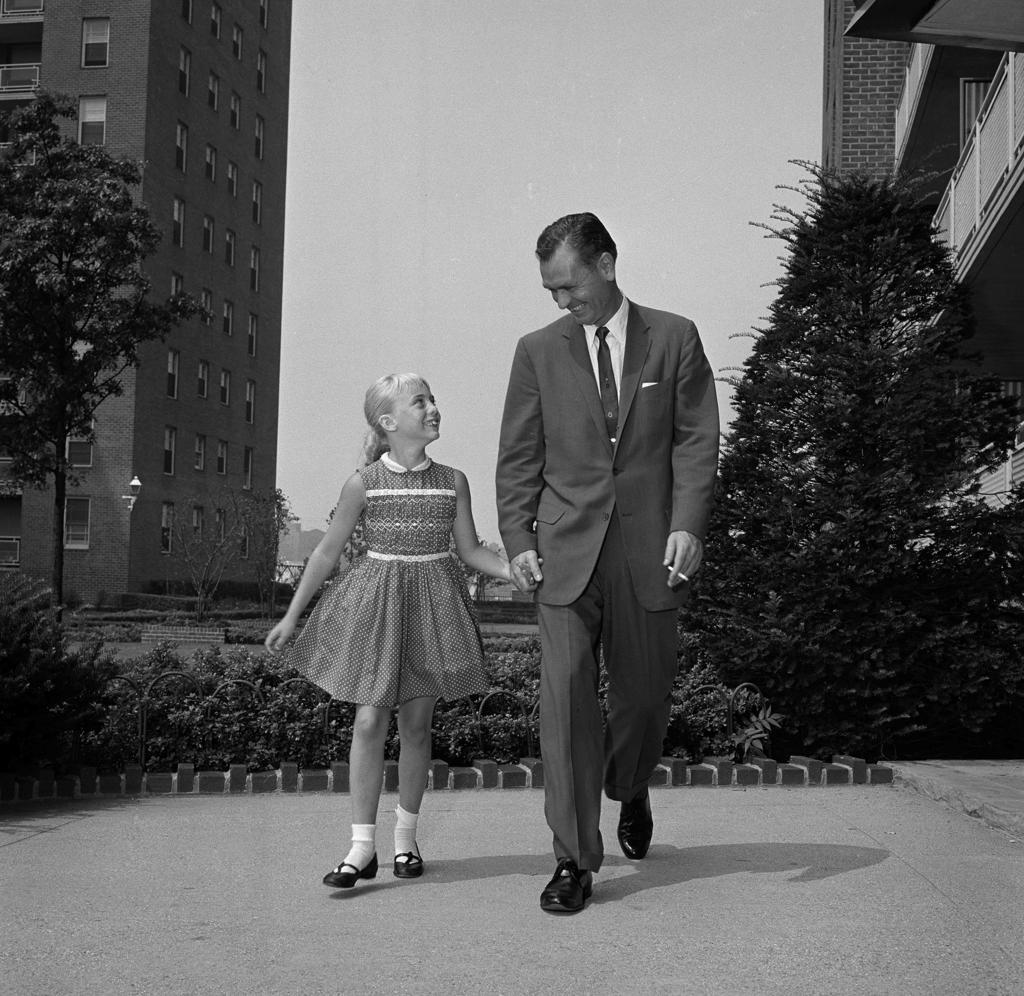 Father walking hand in hand with daughter