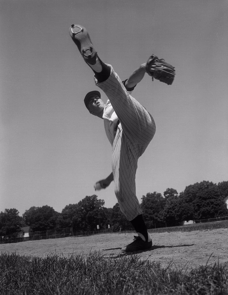 Baseball pitcher standing on one leg