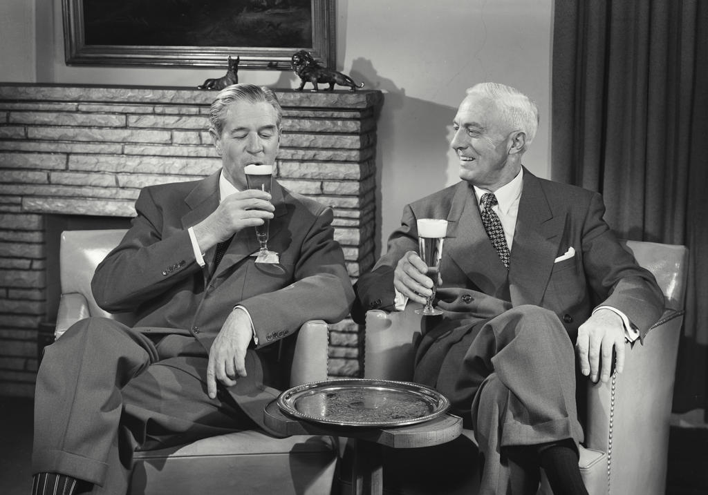 Two mature men drinking beer
