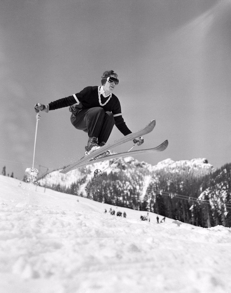 Skier jumping over slope