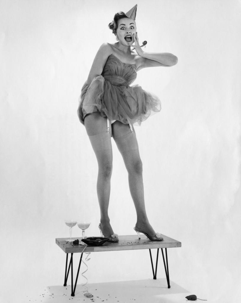 Young woman dancing on a table