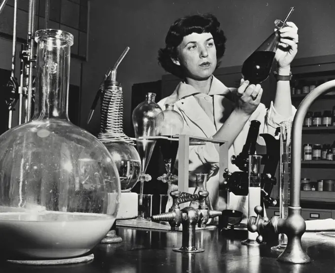Vintage photograph. Research chemist making physical tests on oils and other organic materials at the manufacturing research laboratories