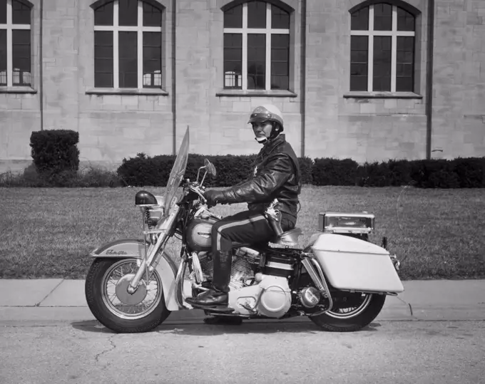 Side profile of a policeman riding a motorcycle