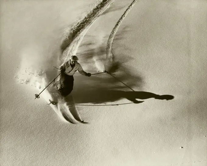 High angle view of a young man skiing downhill
