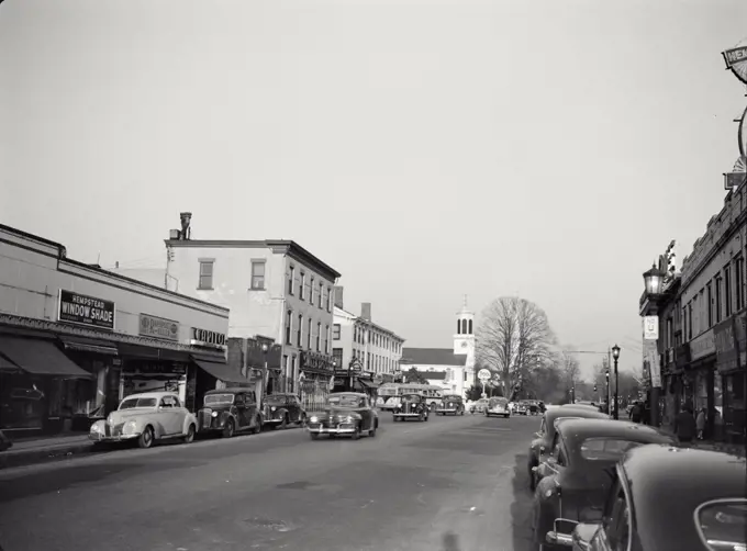Vintage photograph. Busy street scene with vintage cars in Hempstead, Long Island, New York