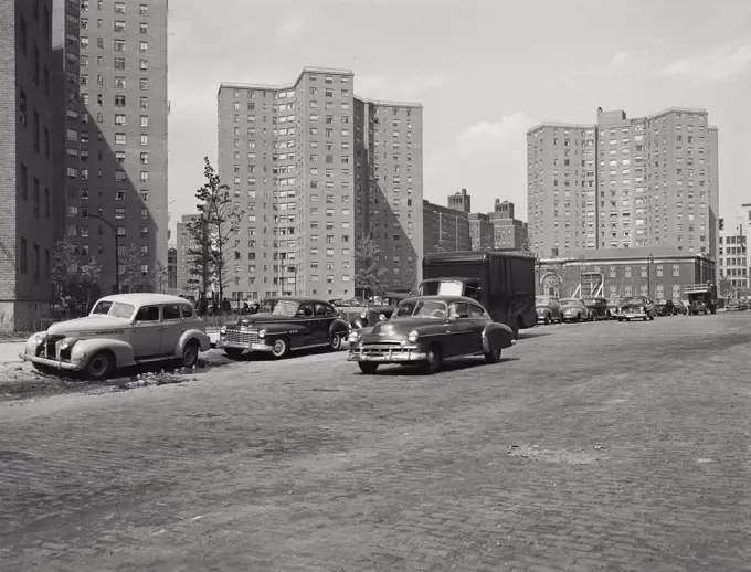 Vintage photograph. Cars drive by units of the Alfred E Smith Housing Project on the Lower East Side