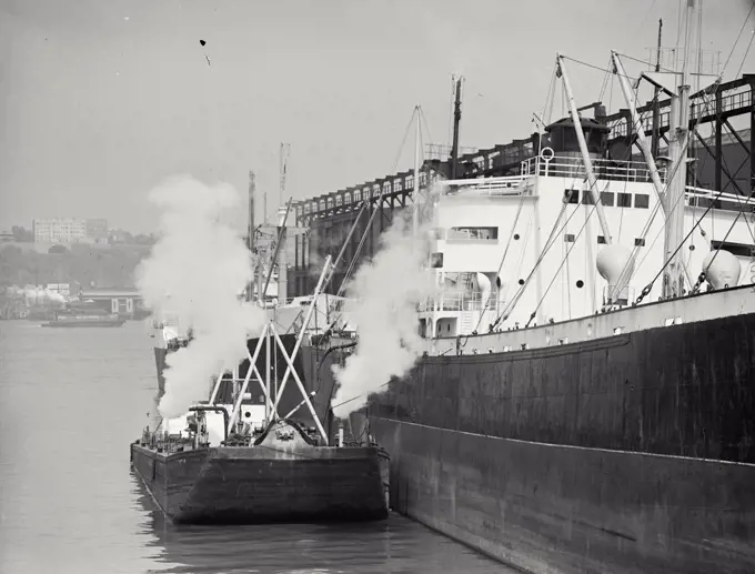 Vintage photograph. Ship blowing steam in dock on North River