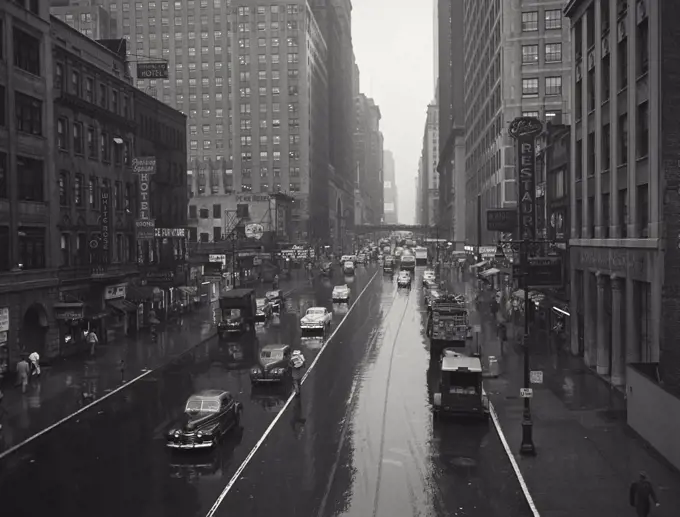 Vintage photograph. Busy Manhattan street in the rain