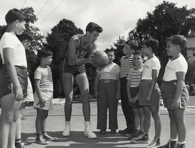 Vintage photograph. Instructor teaching basketball