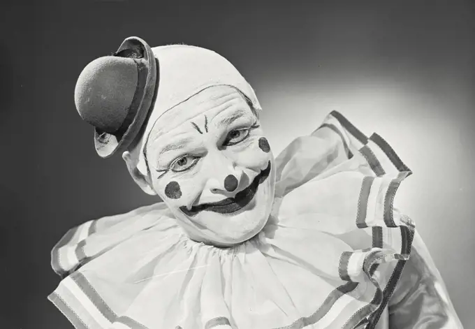 Vintage photograph. Portrait of clown wearing silly hat