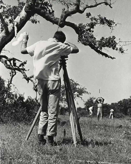 Vintage photograph. Shell oil Company employees surveying Houston Texas