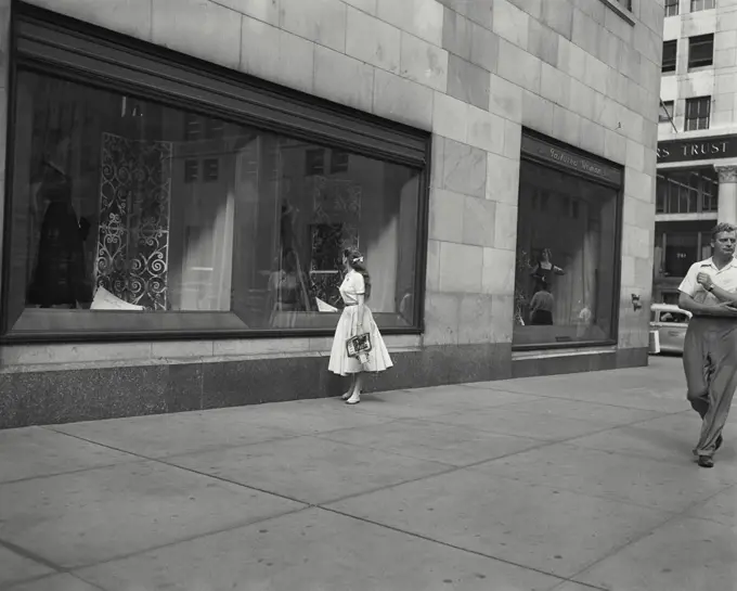 Vintage photograph. woman gazing in shop window